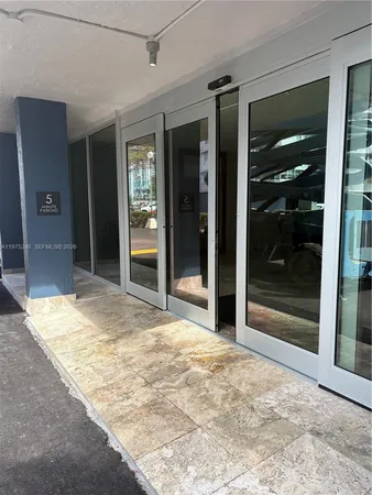a view of garage with wooden floor and door