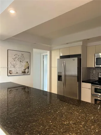 a view of a hallway with a kitchen