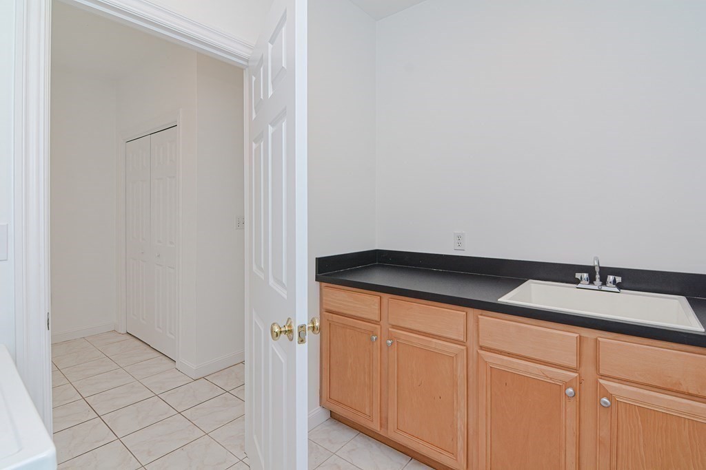 2 Braeburn Lane, Unit 2 Ashland, MA 01721 - Photo 16 of 36 a bathroom with a sink and vanity
