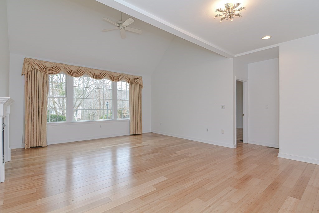 2 Braeburn Lane, Unit 2 Ashland, MA 01721 - Photo 17 of 36 a view of an empty room with wooden floor and a window