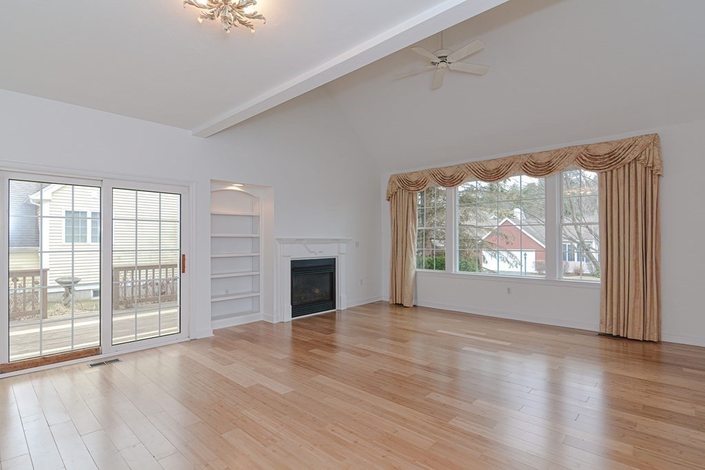 2 Braeburn Lane, Unit 2 Ashland, MA 01721 - Photo 18 of 36 an empty room with wooden floor and windows