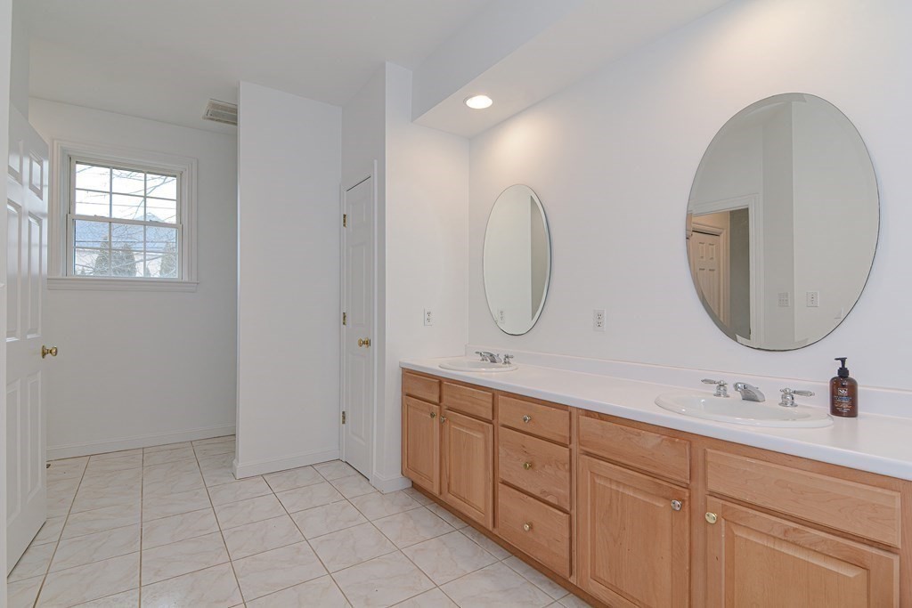 2 Braeburn Lane, Unit 2 Ashland, MA 01721 - Photo 24 of 36 a spacious bathroom with a double vanity sink and a mirror