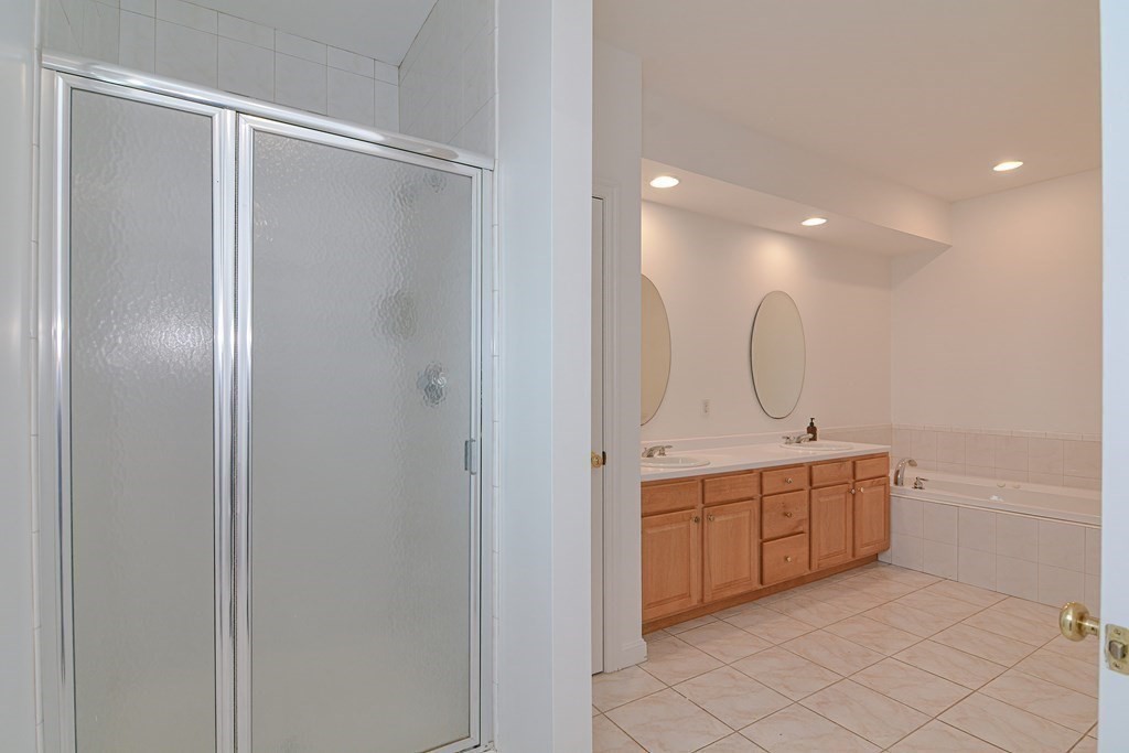 2 Braeburn Lane, Unit 2 Ashland, MA 01721 - Photo 25 of 36 a bathroom with a double vanity sink and mirror