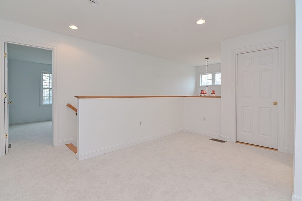 2 Braeburn Lane, Unit 2 Ashland, MA 01721 - Photo 26 of 36 an empty room with entrance and mirror