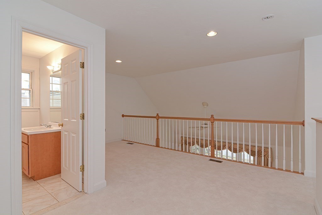 2 Braeburn Lane, Unit 2 Ashland, MA 01721 - Photo 27 of 36 a view of a hallway with bathroom and shower