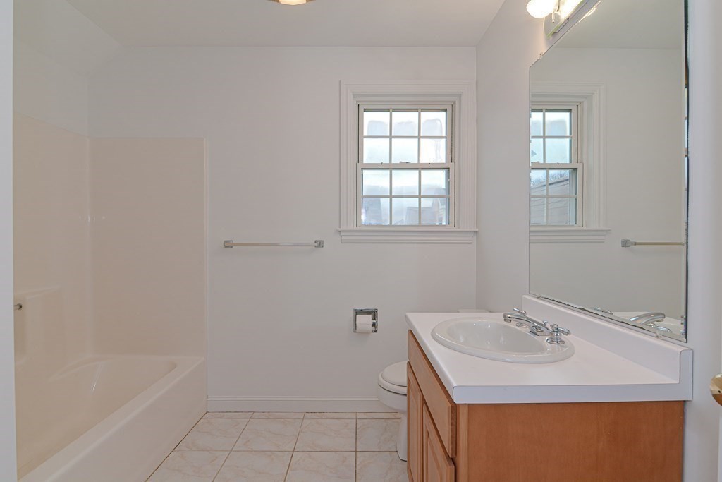 2 Braeburn Lane, Unit 2 Ashland, MA 01721 - Photo 30 of 36 a bathroom with a sink a vanity and a mirror