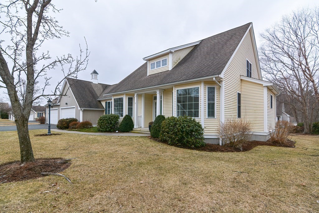 2 Braeburn Lane, Unit 2 Ashland, MA 01721 - Photo 3 of 36 a front view of house with yard and trees around