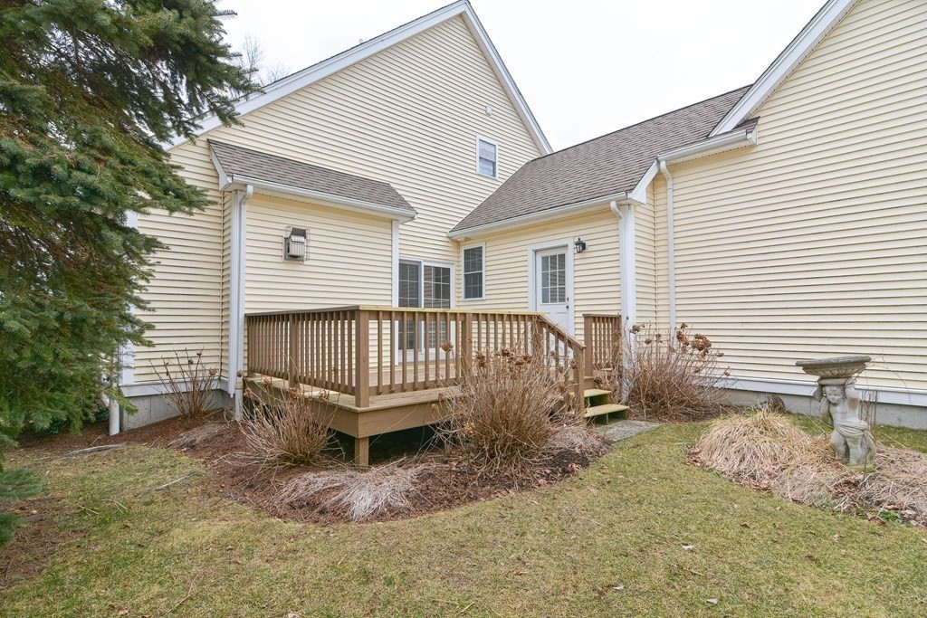 2 Braeburn Lane, Unit 2 Ashland, MA 01721 - Photo 32 of 36 a backyard of a house with table and chairs