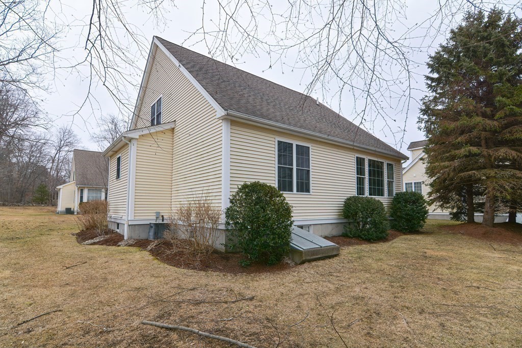 2 Braeburn Lane, Unit 2 Ashland, MA 01721 - Photo 34 of 36 a view of a house with a yard covered in snow