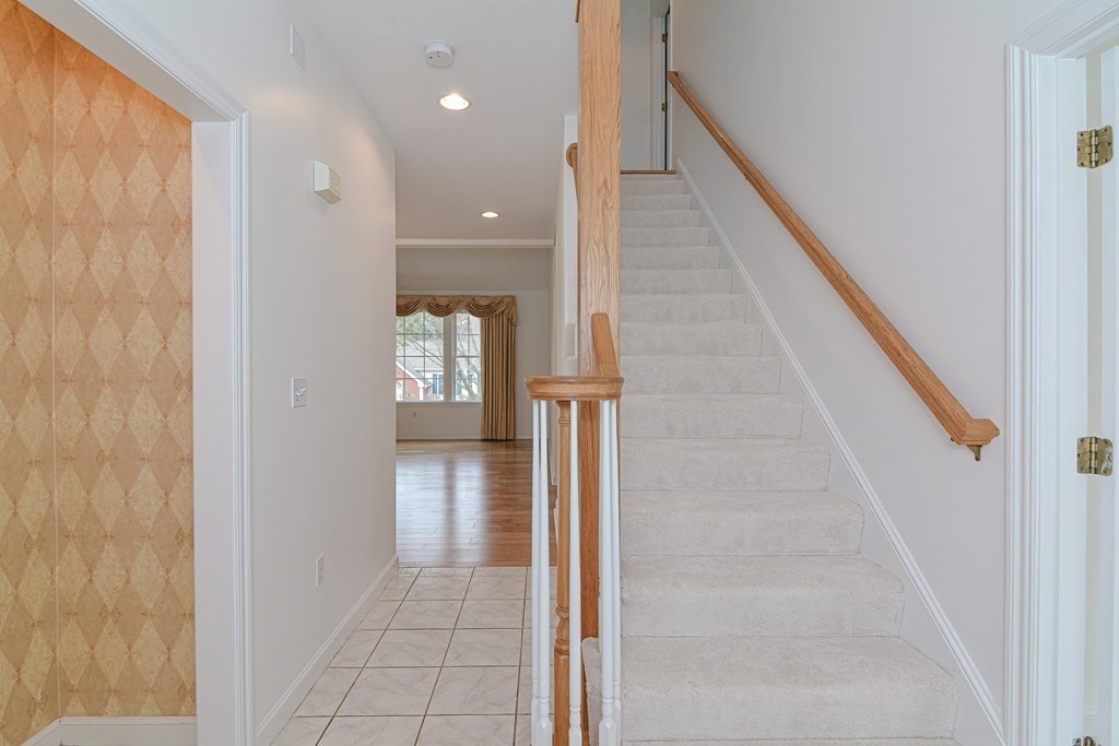 2 Braeburn Lane, Unit 2 Ashland, MA 01721 - Photo 4 of 36 a view of a hallway with wooden floor and staircase