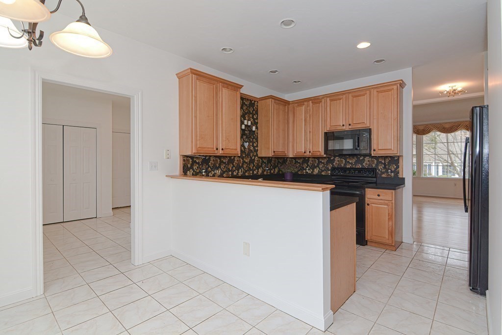 2 Braeburn Lane, Unit 2 Ashland, MA 01721 - Photo 5 of 36 a kitchen with stainless steel appliances a refrigerator sink and microwave