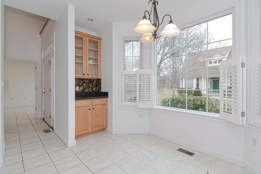 2 Braeburn Lane, Unit 2 Ashland, MA 01721 - Photo 9 of 36 a kitchen that has a lot of windows and sink