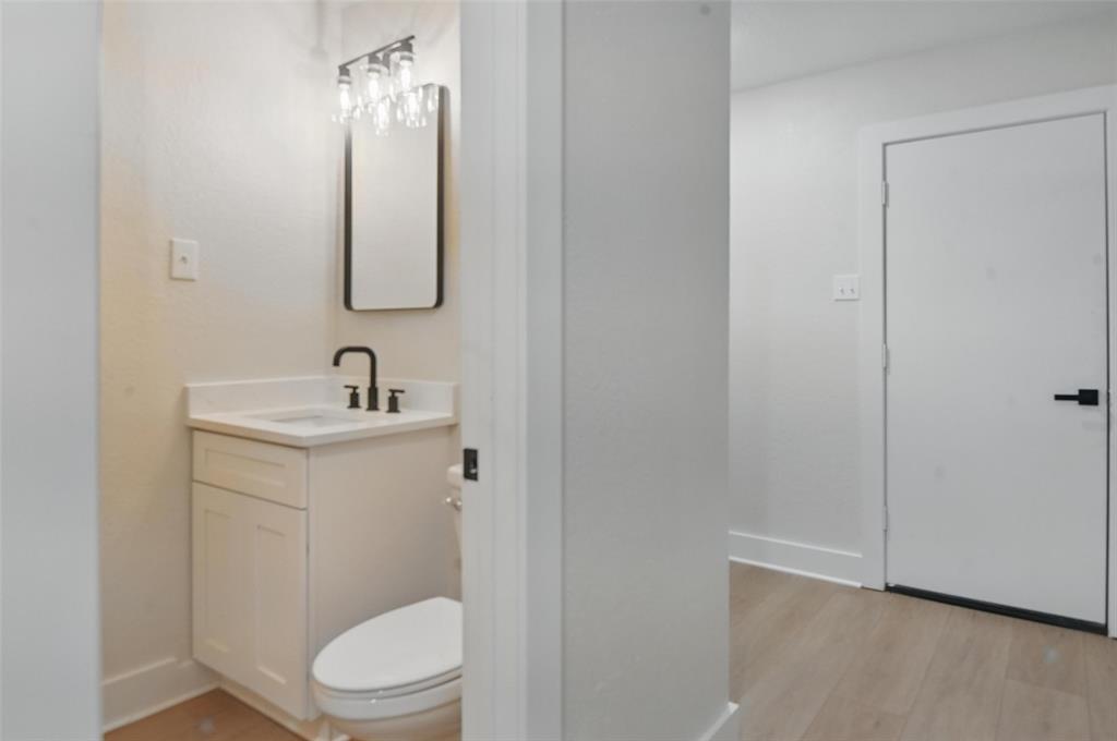 7716 La Risa Drive Dallas, TX 75248 - Photo 11 of 34 a bathroom with a toilet sink and mirror