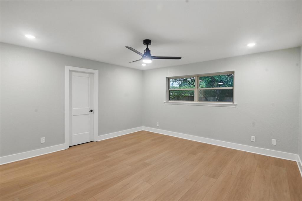 7716 La Risa Drive Dallas, TX 75248 - Photo 17 of 34 an empty room with ceiling fan and windows