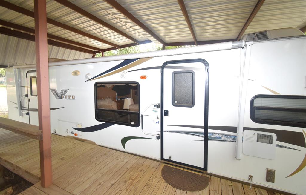 6435 FM 17, Unit 477 Yantis, TX 75497 - Photo 12 of 35 a view of a hallway with wooden floor and staircase