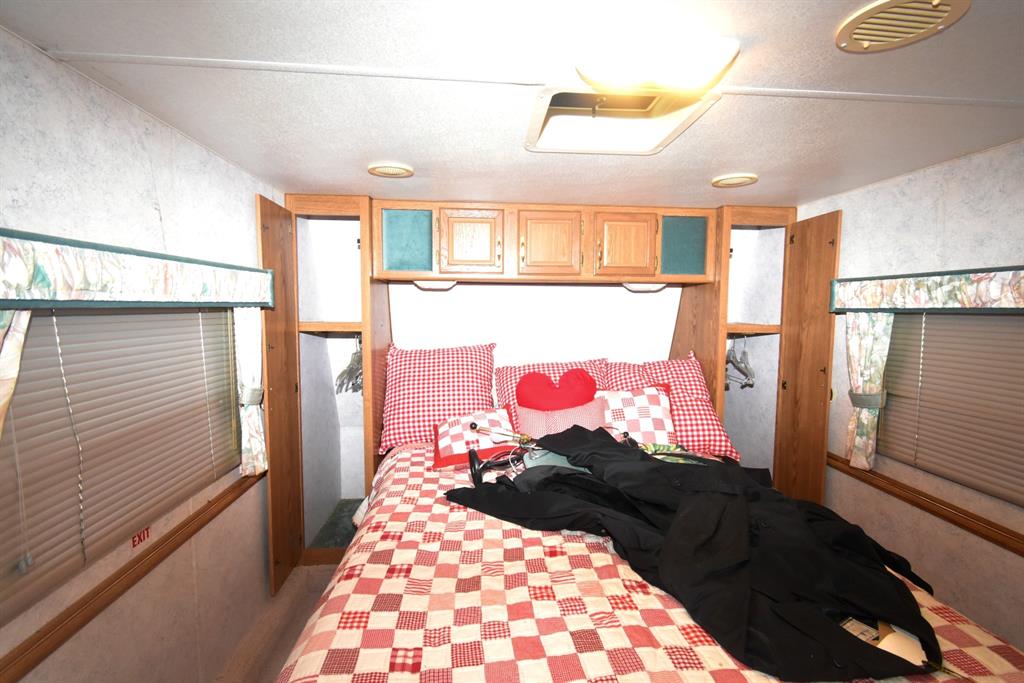 6435 FM 17, Unit 477 Yantis, TX 75497 - Photo 28 of 35 a bed room with a bed and a window