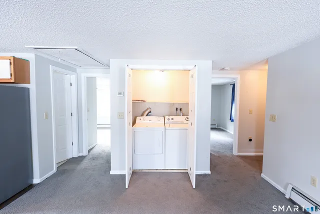 a view of kitchen with refrigerator and sink