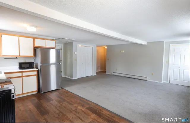 a view of an empty room with a kitchen