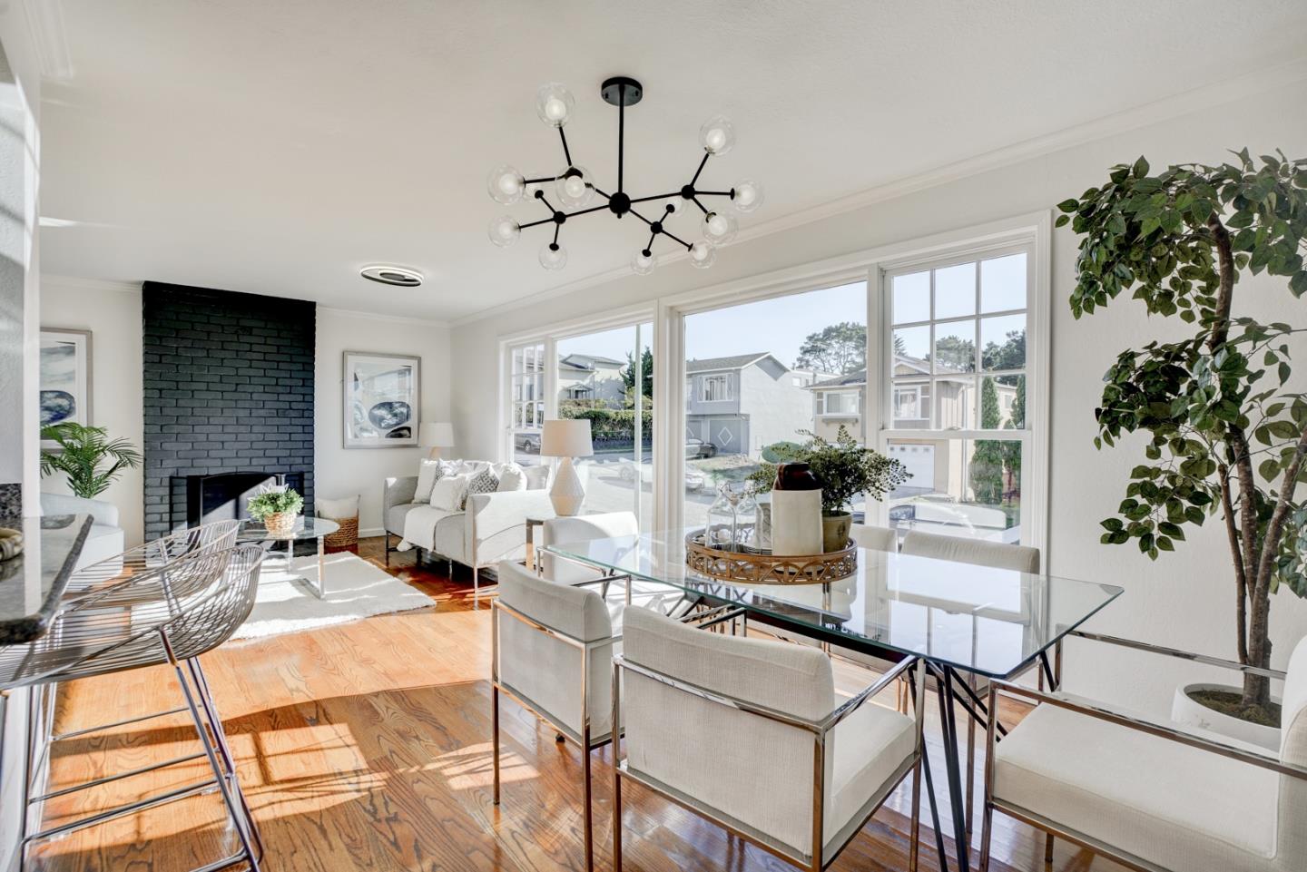 391 Imperial Drive Pacifica, CA 94044 - Photo 14 of 60 a living room with furniture a chandelier and a fireplace