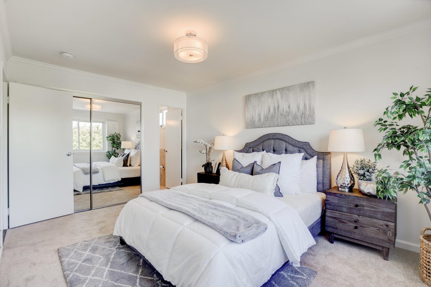 391 Imperial Drive Pacifica, CA 94044 - Photo 23 of 60 a bedroom with a large bed and a potted plant