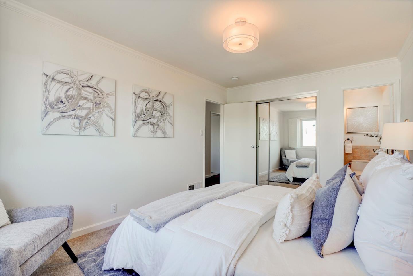 391 Imperial Drive Pacifica, CA 94044 - Photo 24 of 60 a bedroom with a bed and a painting on the wall