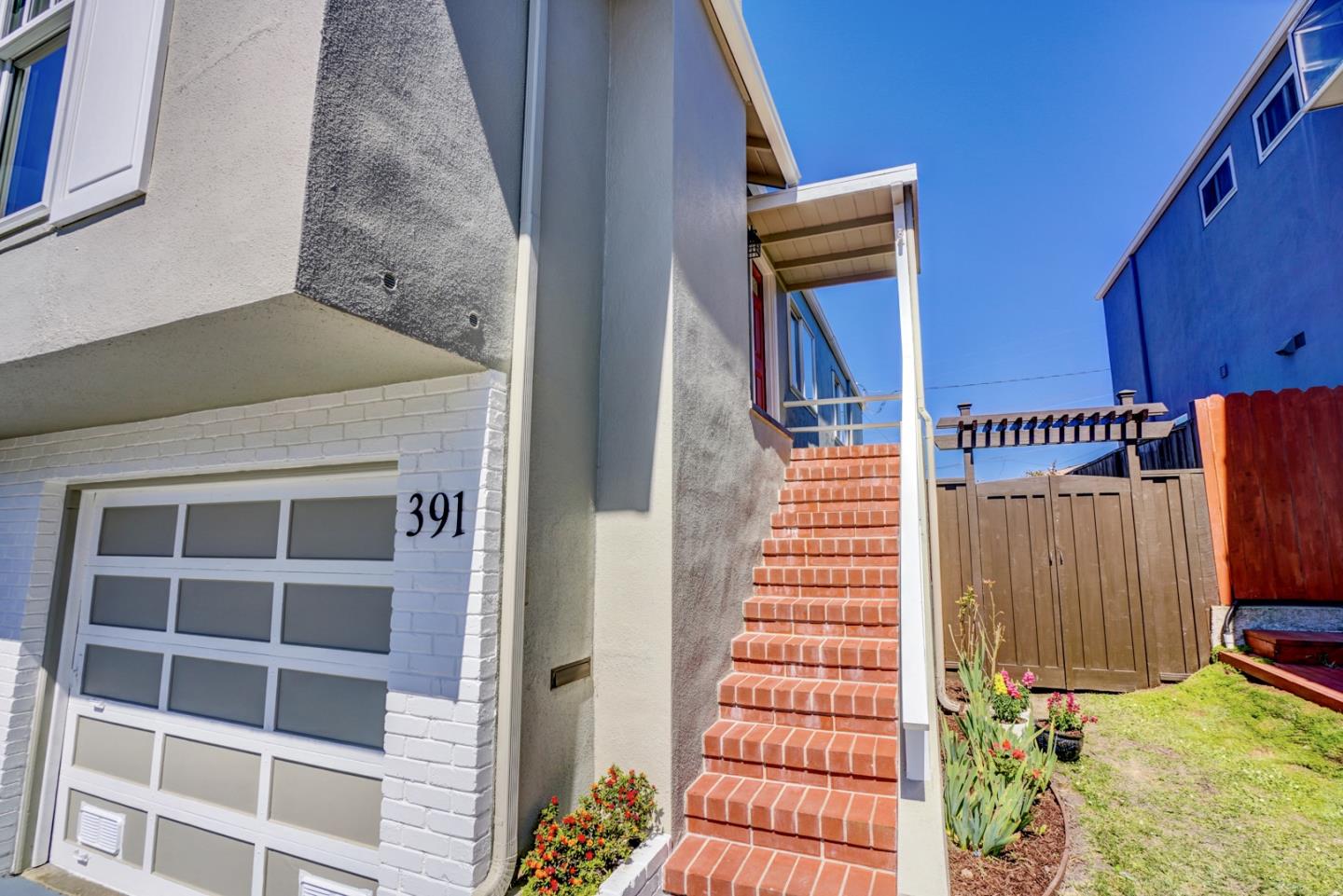 391 Imperial Drive Pacifica, CA 94044 - Photo 4 of 60 a front view of a building with a door and a window