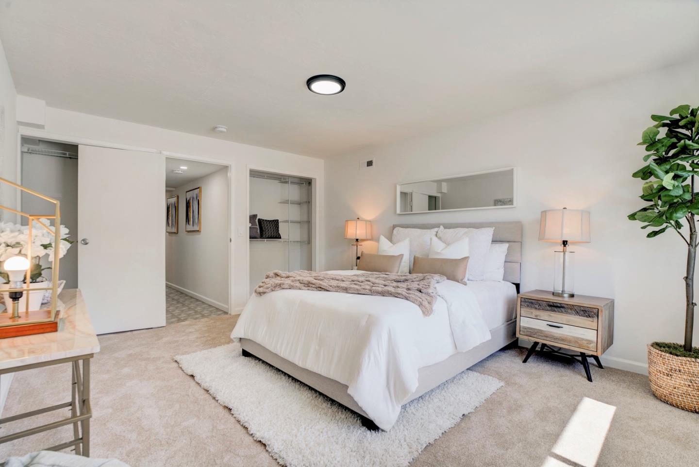 391 Imperial Drive Pacifica, CA 94044 - Photo 47 of 60 a bedroom with bed and a potted plant