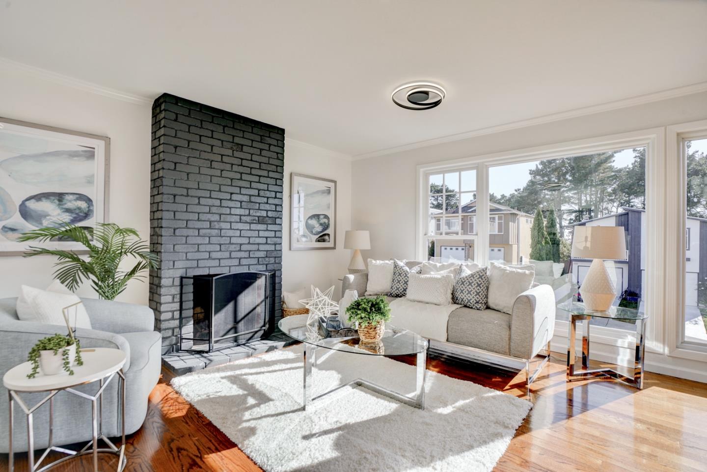 391 Imperial Drive Pacifica, CA 94044 - Photo 8 of 60 a living room with furniture fireplace and a large window