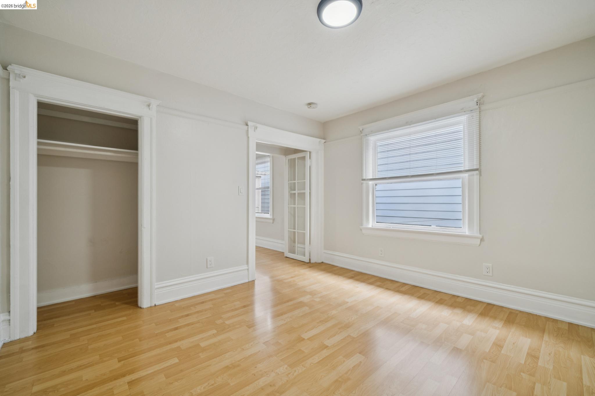 2923 Wheeler Street, Unit C Berkeley, CA 94705 - Photo 14 of 19 a view of an empty room with wooden floor and a window