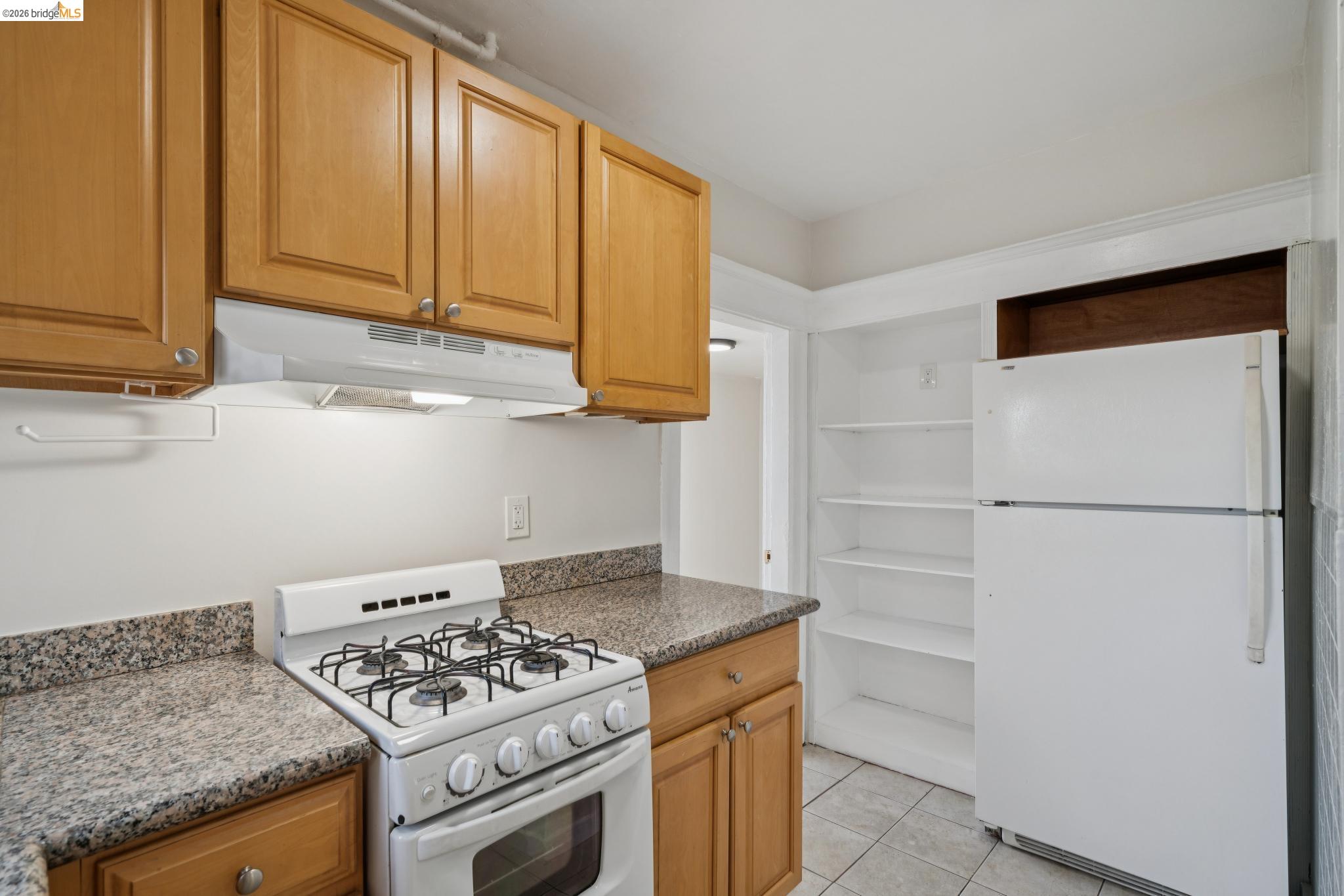 2923 Wheeler Street, Unit C Berkeley, CA 94705 - Photo 7 of 19 a kitchen with stainless steel appliances granite countertop cabinets and a stove top oven