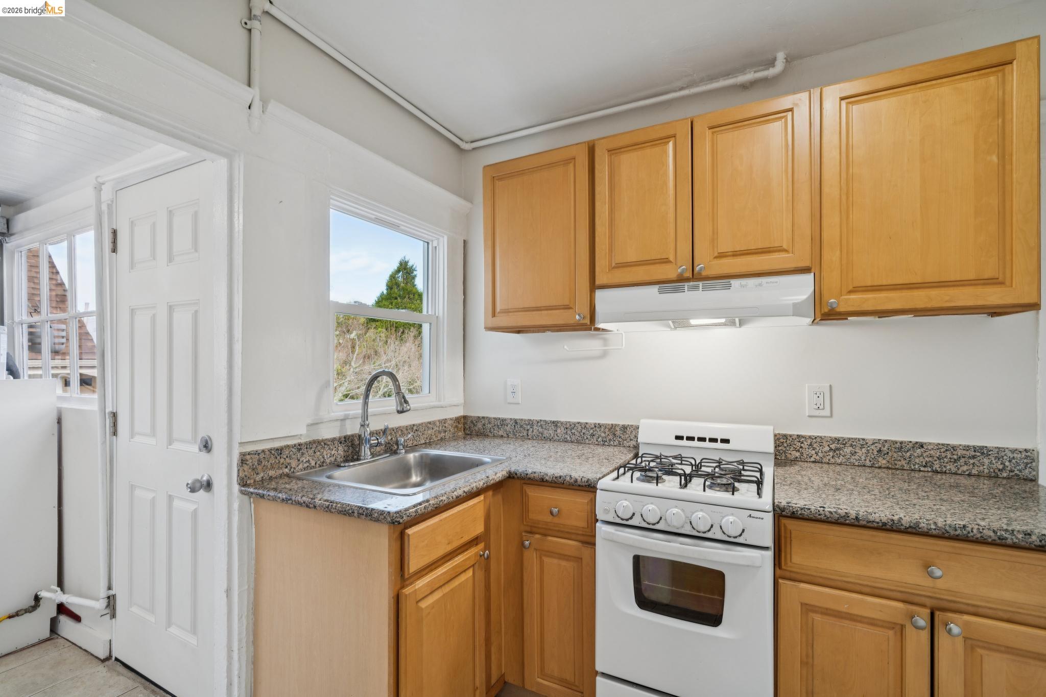 2923 Wheeler Street, Unit C Berkeley, CA 94705 - Photo 8 of 19 a kitchen with granite countertop cabinets stainless steel appliances and a sink