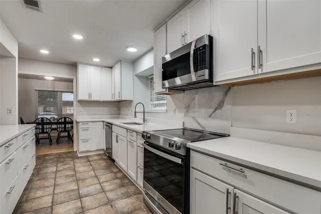 a view of a kitchen counter space cabinets and appliances