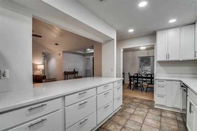 a kitchen with stainless steel appliances kitchen island granite countertop a sink and a stove