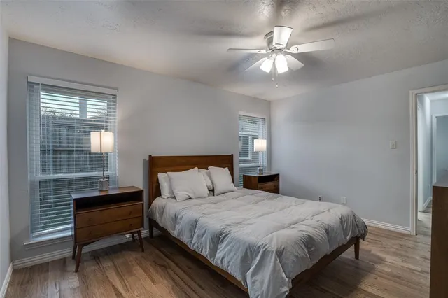 a bedroom with a bed and a ceiling fan