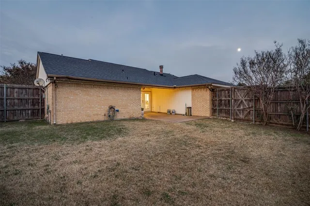 a backyard of a house with table and chairs
