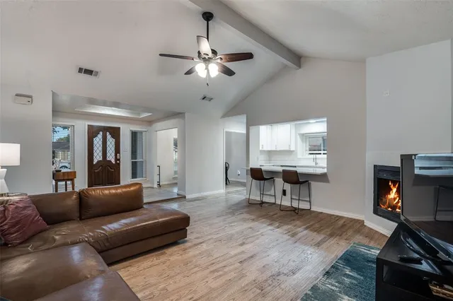 a living room with furniture and a dining table