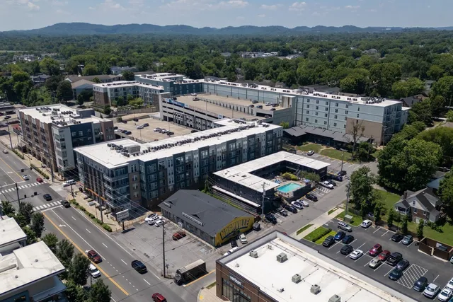 an aerial view of a house with a mountain