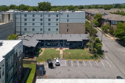 an aerial view of a house with a yard