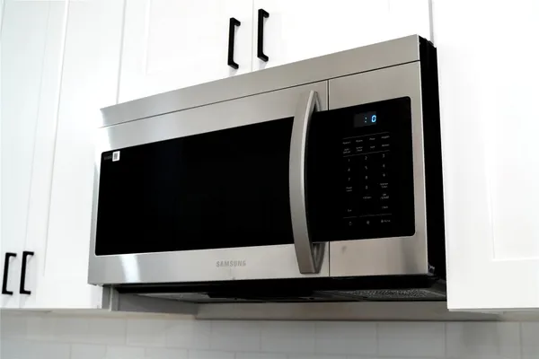 a close view of stove and microwave