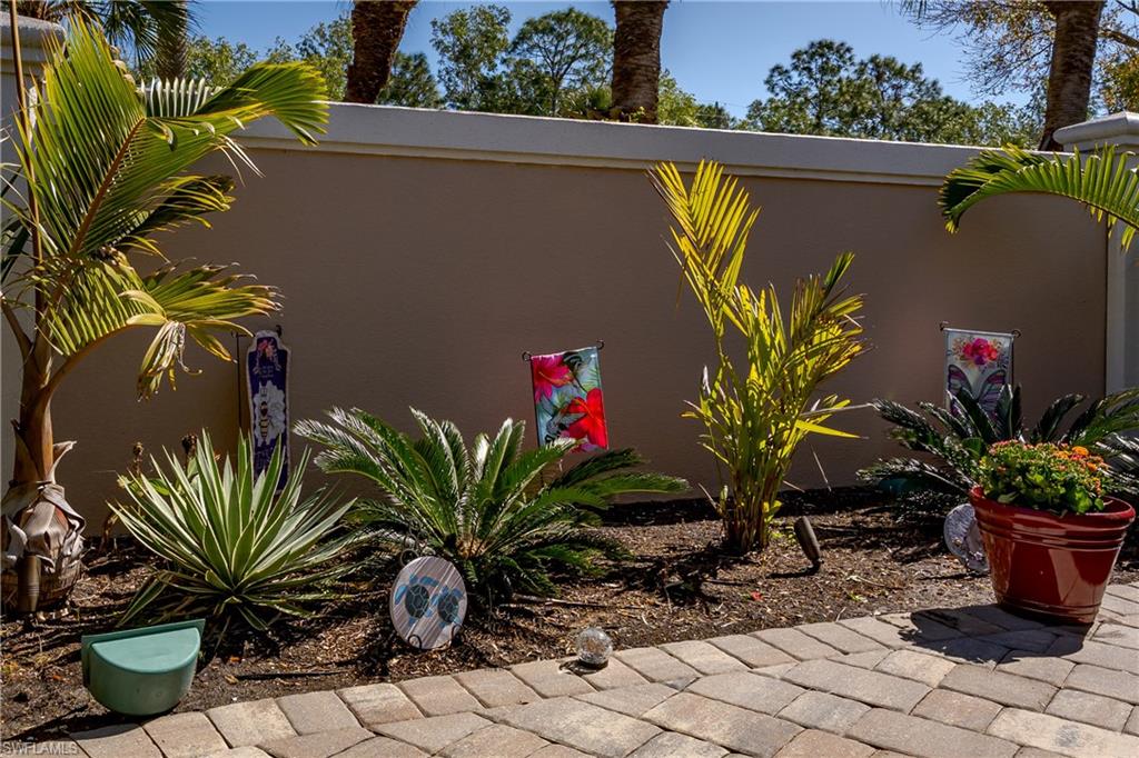 13583 Snook Circle Naples, FL 34114 - Photo 11 of 47 a potted plant sitting in front of a house