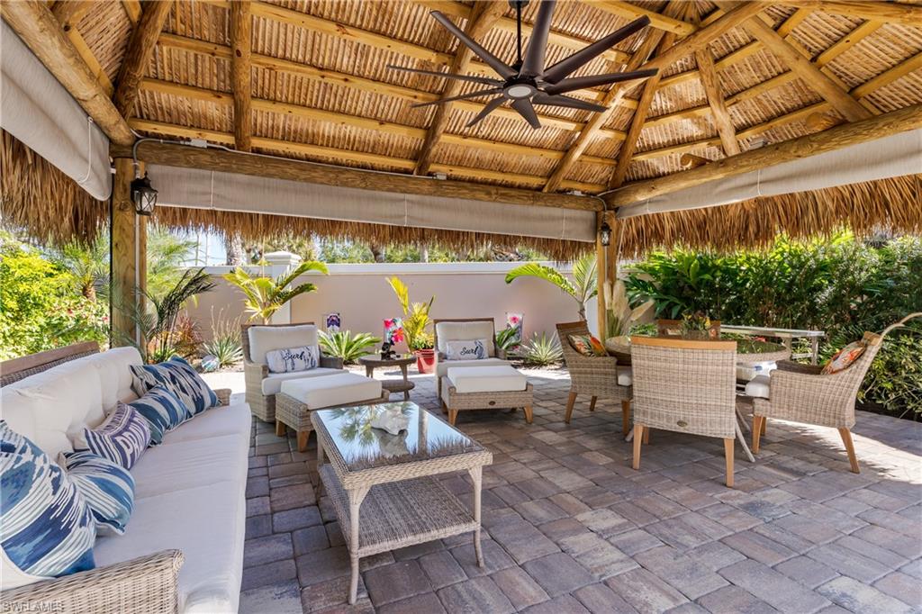 13583 Snook Circle Naples, FL 34114 - Photo 2 of 47 a building outdoor space with patio furniture and potted plants