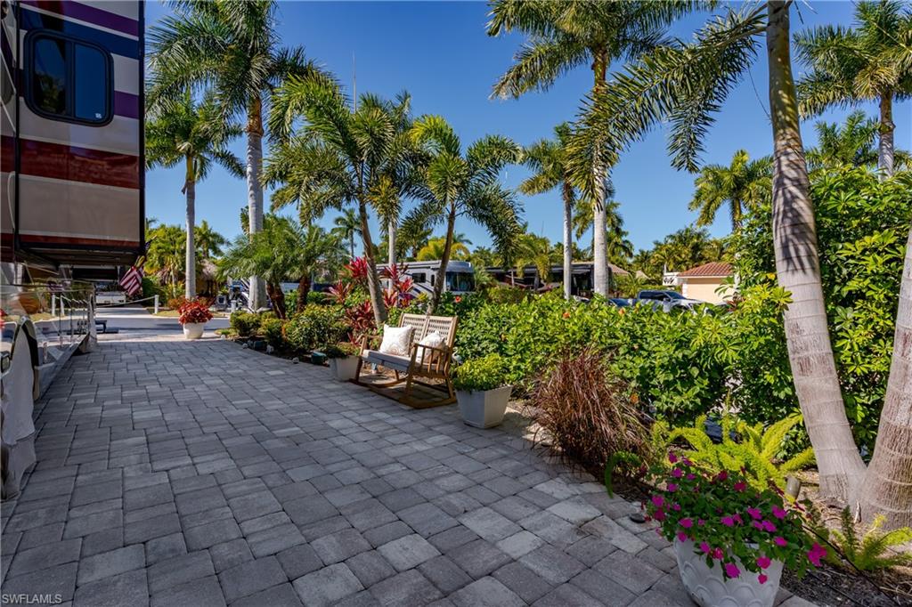 13583 Snook Circle Naples, FL 34114 - Photo 21 of 47 a view of a backyard with plants and palm trees