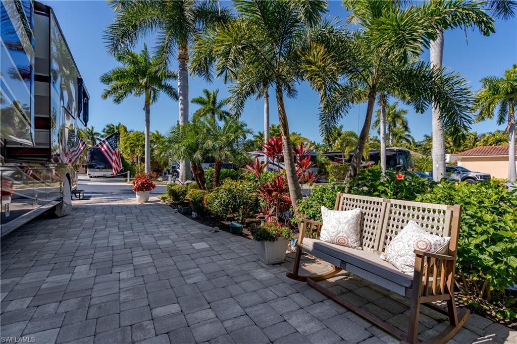 13583 Snook Circle Naples, FL 34114 - Photo 25 of 47 a view of a bench sitting in back yard of a house
