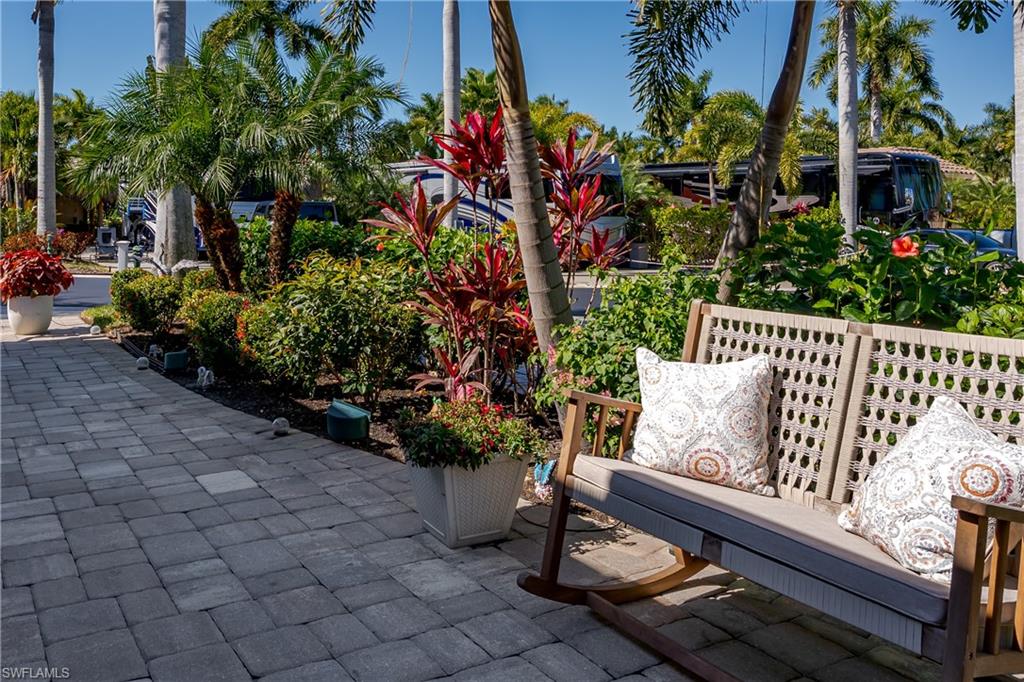 13583 Snook Circle Naples, FL 34114 - Photo 26 of 47 a wooden bench sitting in front of a building