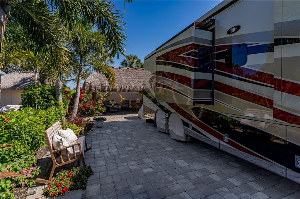 13583 Snook Circle Naples, FL 34114 - Photo 36 of 47 a backyard of a house with barbeque oven table and chairs