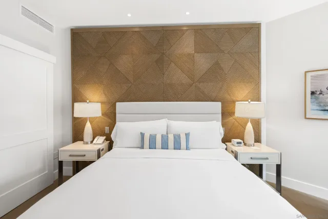 a bedroom with a bed and a night stand