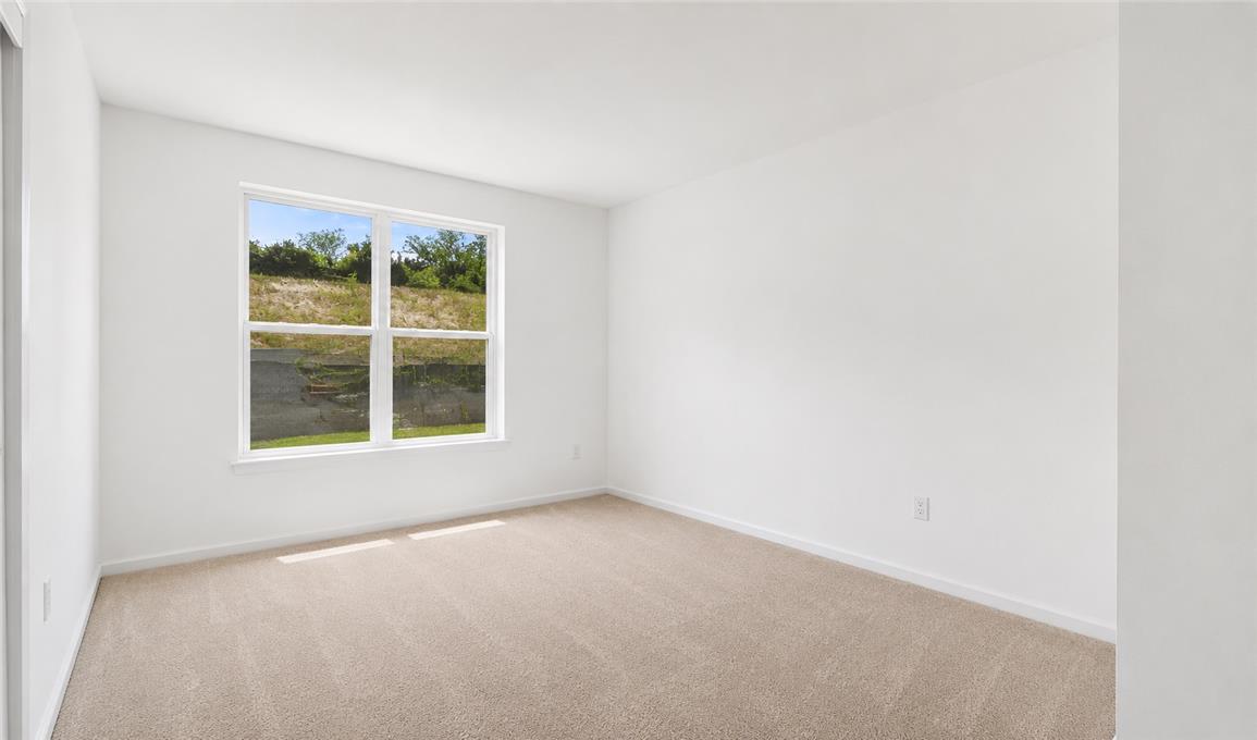 309 Hill Road Whitehall, PA 18052 - Photo 10 of 19 A spacious room with a generously sized window offers verdant outdoor views.