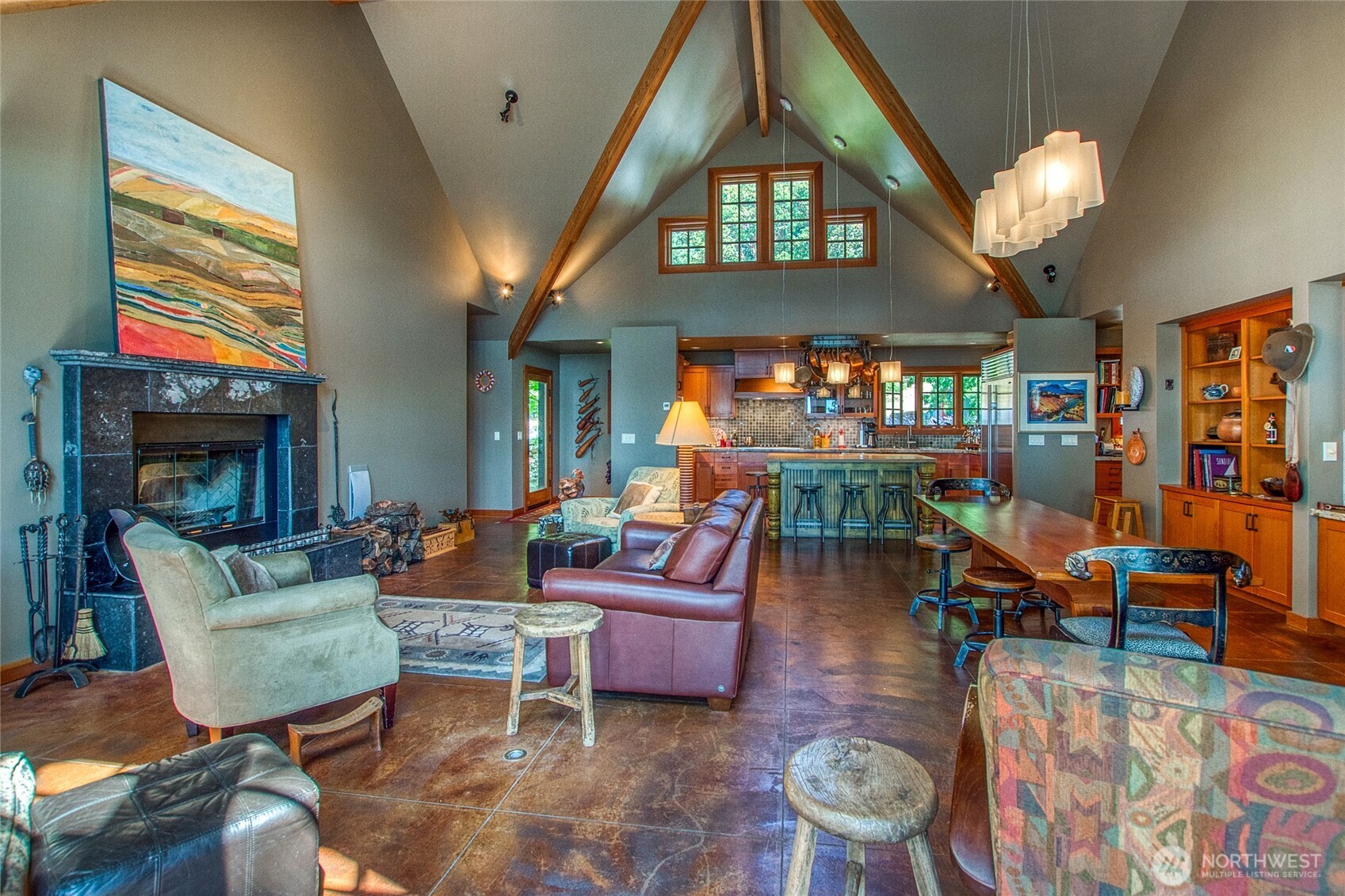 64 Hammond Lane Orcas Island, WA 98245 - Photo 11 of 39 a living room filled with furniture a chandelier a fireplace and a large window