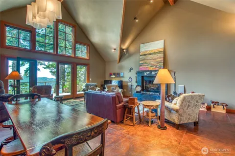 a living room with fireplace furniture and a large window