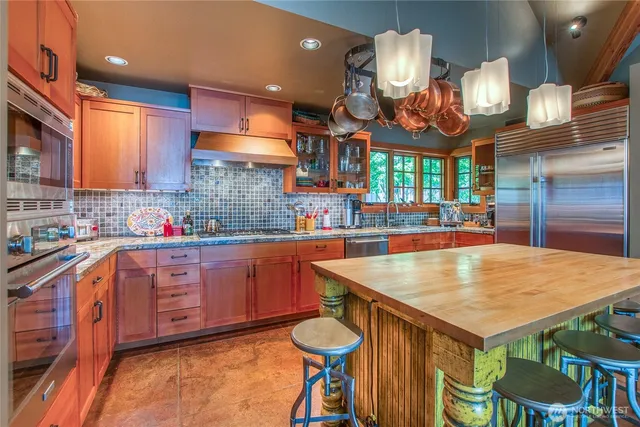 a kitchen with stainless steel appliances a sink and cabinets
